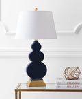 Totally Chic Navy Blue And Gold Ceramic Table Lamp With White Linen Shade, Sleek Mid Century Triple Gourd Design For Bedroom Or Office, 29 Inch Tall Bedside Lamp With LED Bulb Included on a table
