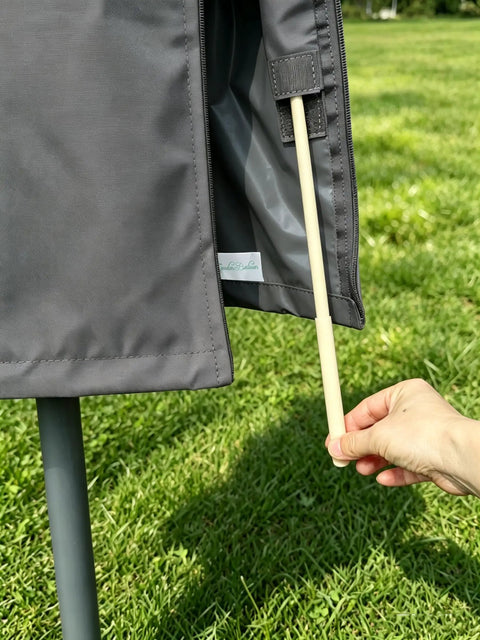Close-up of All-Weather 6ft To 9ft Patio Umbrella Cover With Zipper And Rod, dark grey, showing zipper and rod.