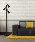 Dual Bulb Desk Lamp With Brushed Steel Base And Black Shade Adjustable Brightness For Home Office Or Bedroom Modern Industrial Style With Wood Accent Great Reading And Task Lighting next to a modern sofa and yellow cushions