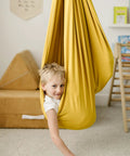 Child in indoor outdoor double layer cotton sensory swing for kids with special needs therapy and vestibular play