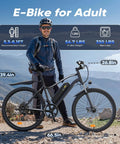 Adult standing with Powerful 1500W Peak Electric Bike For Adults With 80 Mile Range, 20 MPH, 26 Inch Tires on mountain trail