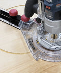 Universal 7 Inch Router Base Plate With Adjustable Swivel Wings And Clear Top For Sharp Vision in use with router and template on wood.