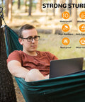 Person in hammock using laptop, with infographic showing features like waterproof and rust-proof. Outdoor setting, trees in background.