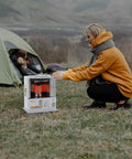 Person using HeatMate Portable Kerosene Heater For Indoor And Outdoor Use 10000 BTU Cordless Space Heater For Home Office Garage Basement And Camping In Any Weather outside a tent