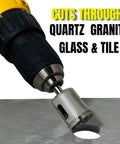 1-inch diamond drill bit attached to a yellow cordless drill, cutting a round hole in metal.