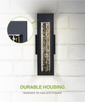 Lit Bubble Glass Tube Wall Sconce With Crystal Look, 12W LED waterproof light on white brick wall highlighting rust resistance.
