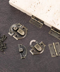 Antique Bronze Jewelry Box Hinges And Latches Set For Wooden Boxes With 2 Antique Hasps And 4 Small Hinges And 24 Matching Screws Retro Metal Hardware shown on a surface
