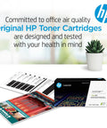 Box of Original HP Toner Cartridges next to color printouts and plant, promoting air quality commitment and health in office.