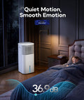 No Window Portable Evaporative Air Cooler With Remote Control 3 Speed Settings 4 Modes 7 Hour Timer Ice Packs Bladeless Quiet Design White Bedroom Cooling Alternative in a dimly lit bedroom next to sleeping person.
