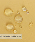Close-up of waterproof material showing droplets on Yellow 60 Inch Round Outdoor And Indoor Tablecloth With Umbrella Hole And Zipper Wrinkle Free Washable Waterproof Round Table Cover For Spring Summer Patio Picnics BBQs Parties.