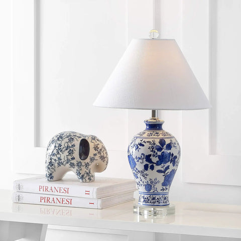 Blue And White Chinoiserie Floral Ceramic Table Lamp With Crystal Base And White Linen Shade Classic Vase Style Living Room Lighting With A Lit Vibe LED Bulb Included ETL Listed on white table next to books and elephant figurine.