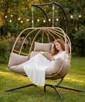 Double Egg Chair Outdoor With Stand For Two People Cushions And Headrest 80 Inch Hanging Swing Chair Basket In Brown in a garden
