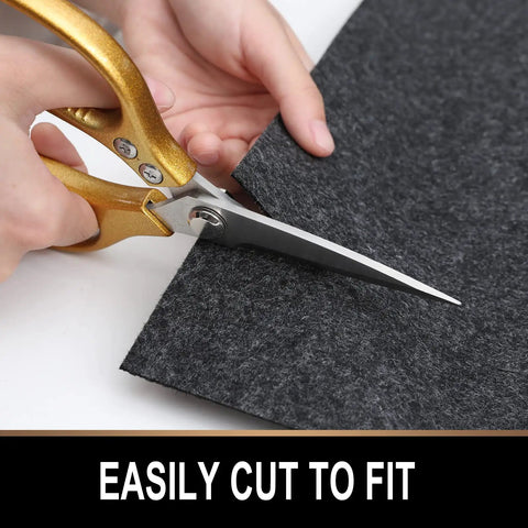 Person cutting Oil Spill Mat For Garage Floor 7.4 By 8.4 Feet Premium Absorbent Pad With Waterproof Rubber Backing with scissors