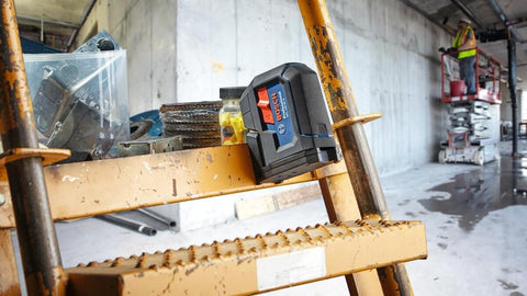 Green Beam Self Leveling Alignment Laser Pro Grade With Plumb And Level Point Projection on a construction site ladder