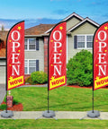 Now Open Feather Flag Pole Kit With Ground Stake Water Bag And Travel Bag displayed at a real estate open house