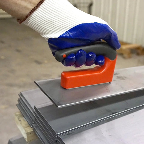 Side view of Master Magnetics strong magnet with ergonomic orange handle pressed onto steel sheets.
