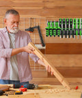 Man working with wood in garage next to a Heavy Duty Wall Mounted Tool Organizer For Pliers And Small Tools Metal Screwdriver Holder Rack With 23 Holes.