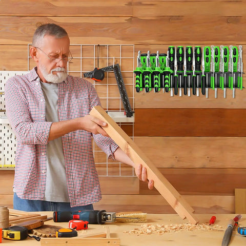 Man working with wood in garage next to a Heavy Duty Wall Mounted Tool Organizer For Pliers And Small Tools Metal Screwdriver Holder Rack With 23 Holes.