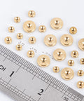 Brass Clock Hand Nut Set 24 Piece Assortment With Outer Diameters 5mm 6mm And 10mm displayed with ruler for size reference