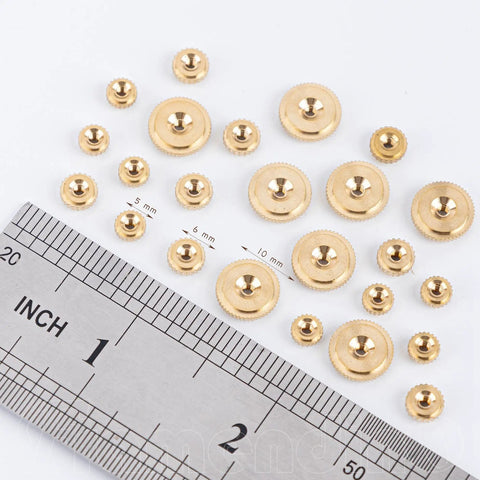 Brass Clock Hand Nut Set 24 Piece Assortment With Outer Diameters 5mm 6mm And 10mm displayed with ruler for size reference