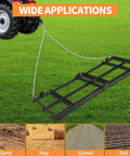 Heavy-Duty Tow-Behind Drag Harrow Driveway Grader for Gravel And Dirt, 8 ft power rake attached to a tractor on grass