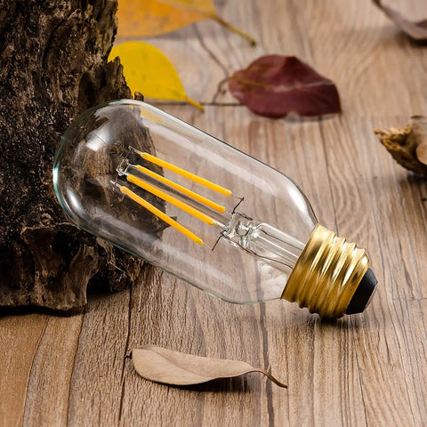 Old School Edison Style LED Filament Tubular Bulb on wood table, warm white 2700K, E26 base, T45 tube, 40W equivalent