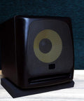 Studio monitor on heavy-duty acoustic foam pad, reducing vibration for 5 to 12 inch monitors and subwoofers, home studio setup.