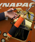 Thinkwork 8000 PSI heavy-duty grease gun kit, orange barrel with brass fittings and pistol grip.