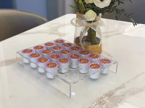 Two Pack 24 Slot Flat Countertop Coffee Pod Holder And Drawer Organizer For Office And Kitchen, Clear Acrylic K Cup Tray Compatible With KCup Pods For Home filled with K-Cups on marble countertop