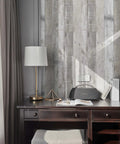 Distressed Wood Peel And Stick Wallpaper Roll 17.71 Inch By 472 Inch Self Adhesive Shiplap Wood Grain wall behind a desk.
