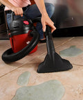 Person using 1.5 Gallon 2.0 Peak Wet Dry Vacuum For Quick Cleanups At Home, Garage, Or Vehicle on spilled liquid on tile floor