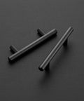 Professional Grade Matte Black Cabinet Pulls For Kitchens And Bathrooms Ultra Smooth Stainless Steel Drawer Handles, two handles on black surface.