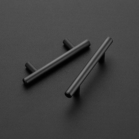 Professional Grade Matte Black Cabinet Pulls For Kitchens And Bathrooms Ultra Smooth Stainless Steel Drawer Handles, two handles on black surface.