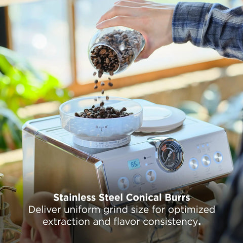 Person pouring coffee beans into Talos Semi Automatic Grind And Brew Espresso Machine With Built In Conical Burr Grinder 20 Bar Italian Pump Real Time Pressure Gauge Stainless Steel Lunar Finish For Barista Level Flavor At Home