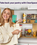 Woman pointing to organized pantry with ClearSpace bins, displaying Pantry Organization Bins With Removable Dividers And Lids Two Pack