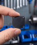 Three Pack Rubber Pressure Switch Gaskets For Air Compressors, Wear-Resistant Seal Pads, Leakproof Switch Seals, Go-To Replacement Spare Parts For Air Pumps And DIY Compressor Repairs. Black rubber gasket held between fingers, close-up.