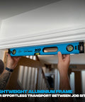 Person using Pro Grade 2 Foot Aluminum Level Box Beam With Magnified Vials Shock Absorbing End Caps on door frame.