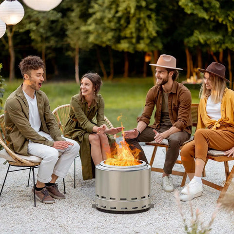 Group enjoying Smokeless Fire Pit For Outdoor Wood Burning With Dual Air Intake Holes, Portable Camping And Patio Fire Pit, silver finish
