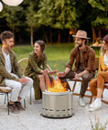 Group of friends enjoying a Smokeless Outdoor Fire Pit 19.5 Inch With Removable Ash Pan, Steel Portable Fire Pit For Backyard Patio