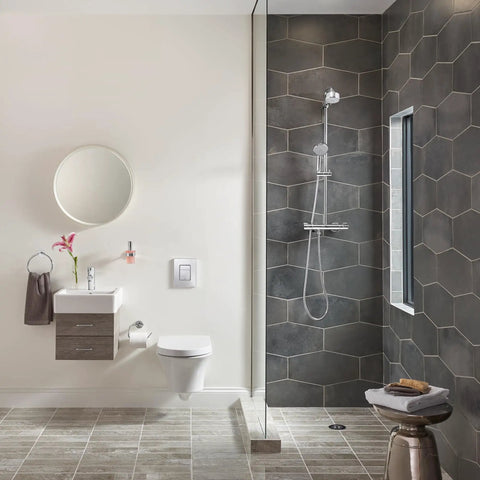 Modern bathroom with Tempesta Cosmopolitan 2.5 GPM 4-Spray Hand Shower in Starlight Chrome mounted on black hexagon tile wall.