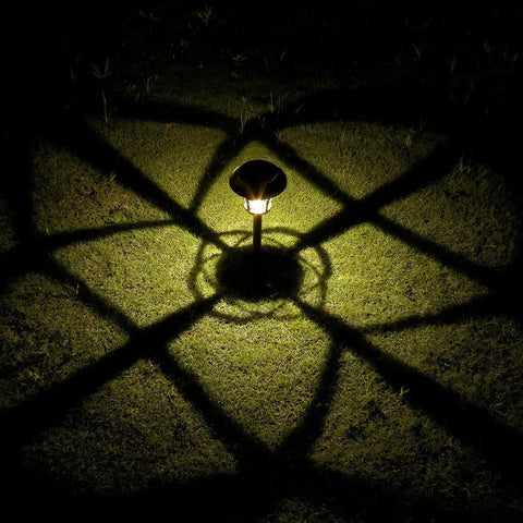 Six Pack Solar Pathway Lights Outdoor Waterproof Garden Lights casting shadows on grass at night, warm white LED.