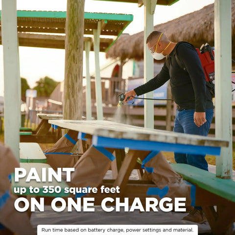 Tough As Nails 18V Cordless Airless Paint Sprayer With Advanced HEA Tech used for painting a picnic table outdoors.