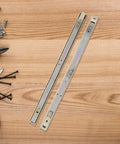 Heavy Duty 27mm Wide Full Extension Ball Bearing Drawer Slides For Keyboard Tray And Nightstand Cabinets Zinc Plated Side Mount Rails 2-Section 450mm Length Durable Galvanized Furniture Hardware on a wooden table with tools and screws nearby.