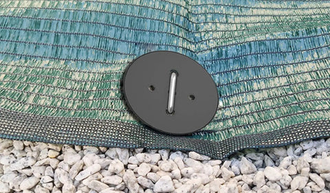 Close-up of 100 Pack 6 Inch Landscape Staples With Gasket Washers for landscaping fabric secured on gravel