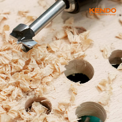 KENDO alloy-steel Forstner drill bit, close-up view cutting wood with shavings on a plywood board