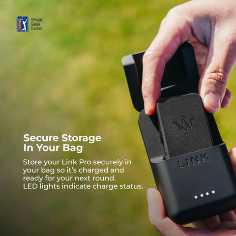 Close-up of Link Pro Wearable Golf Tracker: Auto Tracks Every Shot With AI in charging case, held by hand, showing LED lights.