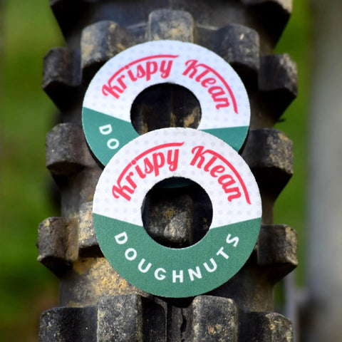 MX Grip Donuts for Dirt Bikes, Motorcycles, and BMX Cushioned Hand Grip Spacers displayed on bike tire