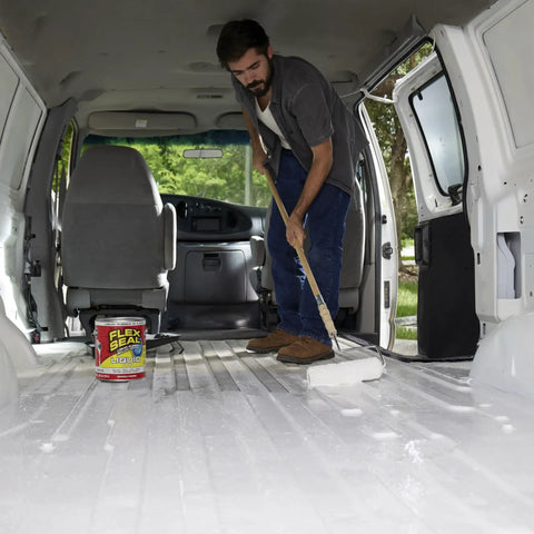 Man applying Liquid Rubber Coating Sealant For Waterproof, Flexible Protection On Roofs, Basements, RVs with brush inside van