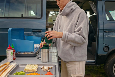 Person using Go 4 Piece Stainless Steel Camp Cook Set With 32 Ounce Pot And Lid Fold And Lock Handle Includes Two Stacking Cups BPA Free
