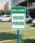 Two Pack Welcome Visitor Parking Sign 18 By 12 Inches Reflective Aluminum Weatherproof Built Tough Safety Sign With Pre Drilled Holes For Home Office Yard Driveway Parking installed in front of a modern building.